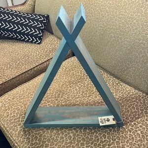 Decorative Teel wooden teepee. Can be sitting or hung on a wall.